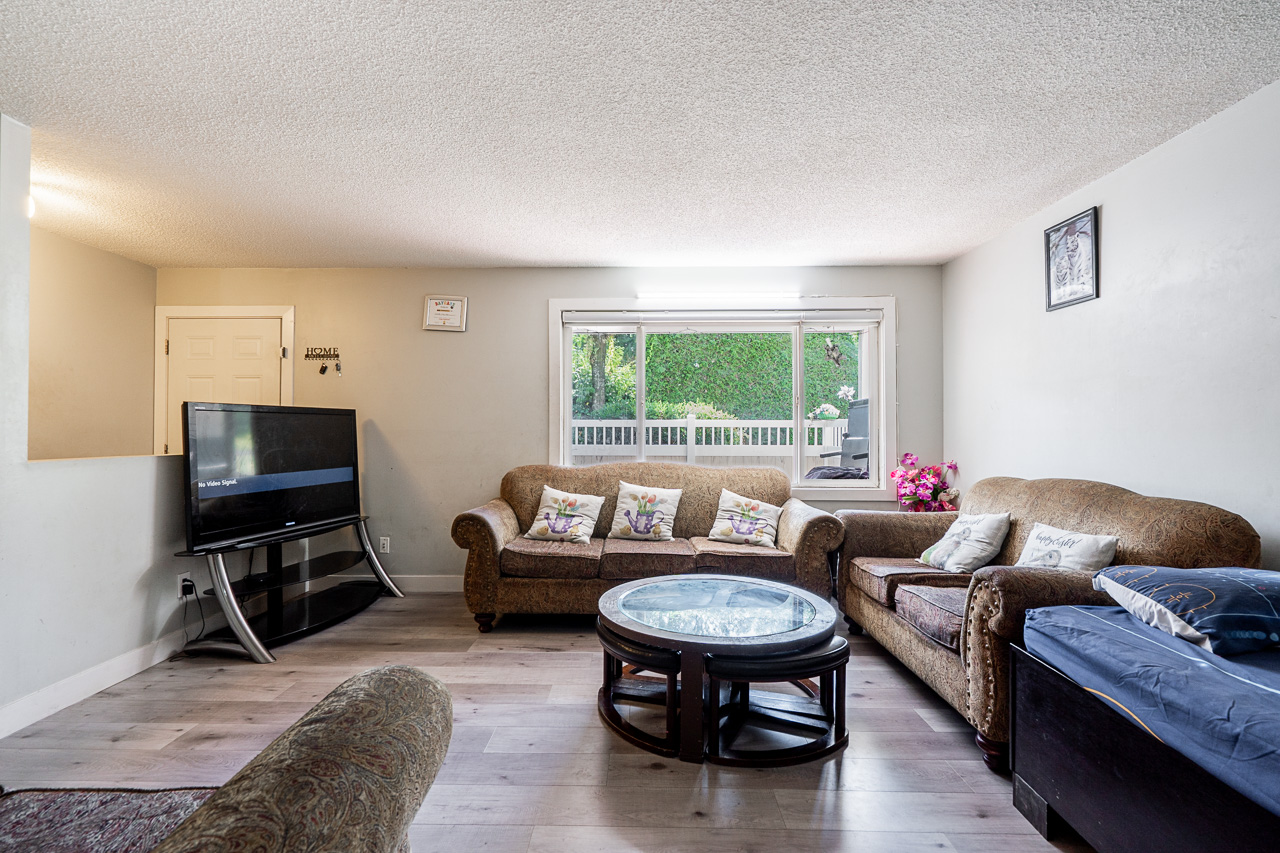 Unit 104 13915 72 Avenue Surrey-10 Spacious living area at 104 13915 72 Avenue featuring modern flooring and natural light.