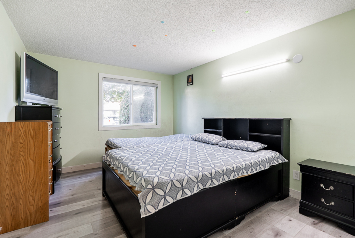 Bright bedroom at 104 13915 72 Avenue, Surrey with large window and closet space.
