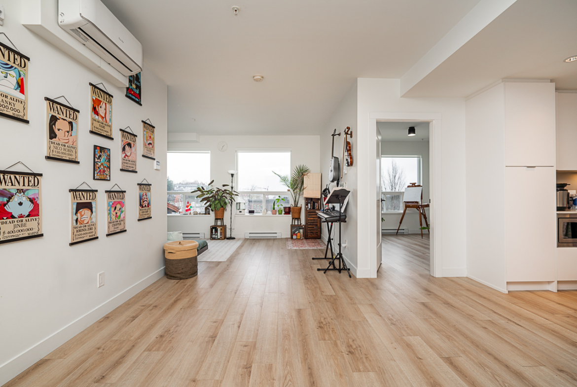 Bright open-concept living room with large windows and city views