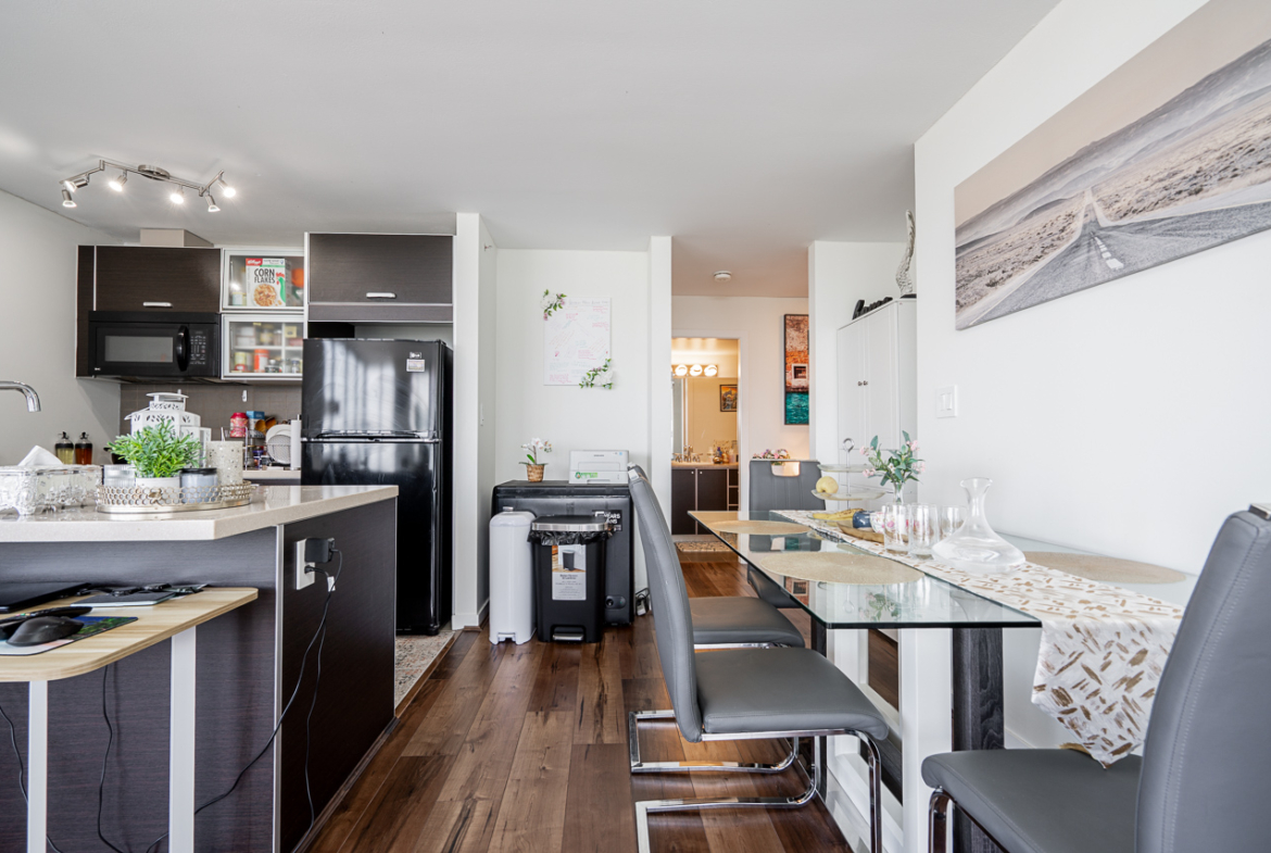 Open-concept dining area with modern lighting and city views
