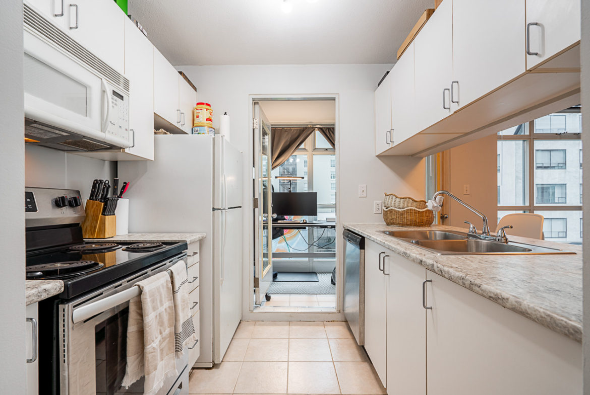 Open-concept kitchen with stainless appliances at 504–438 Seymour Street