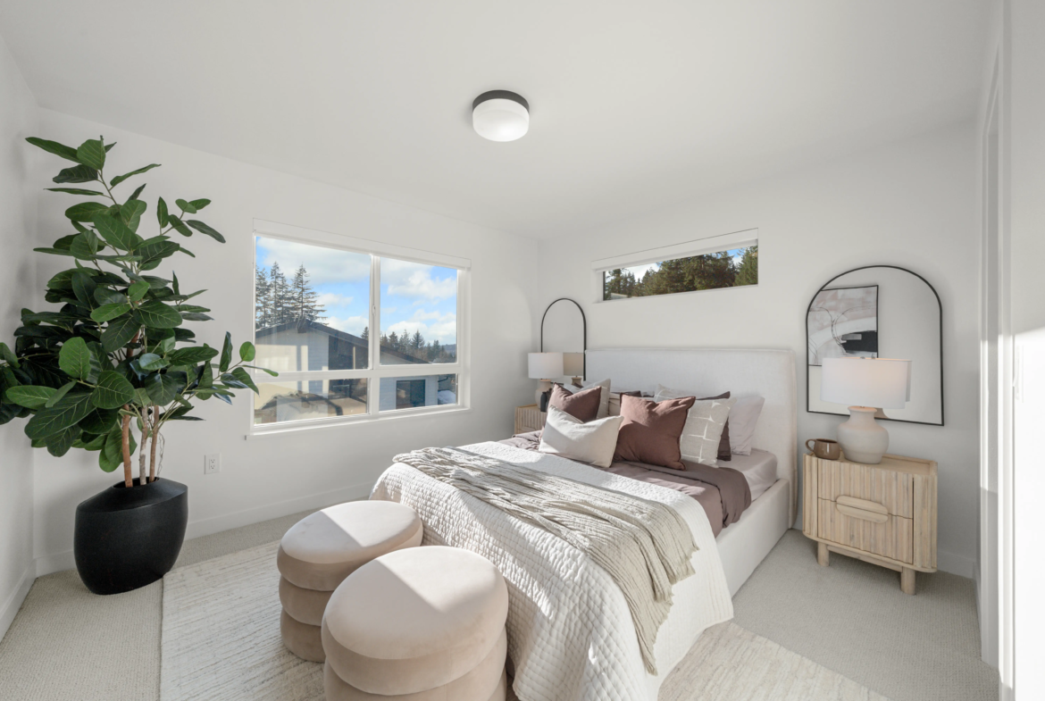 Spacious primary bedroom with mountain views